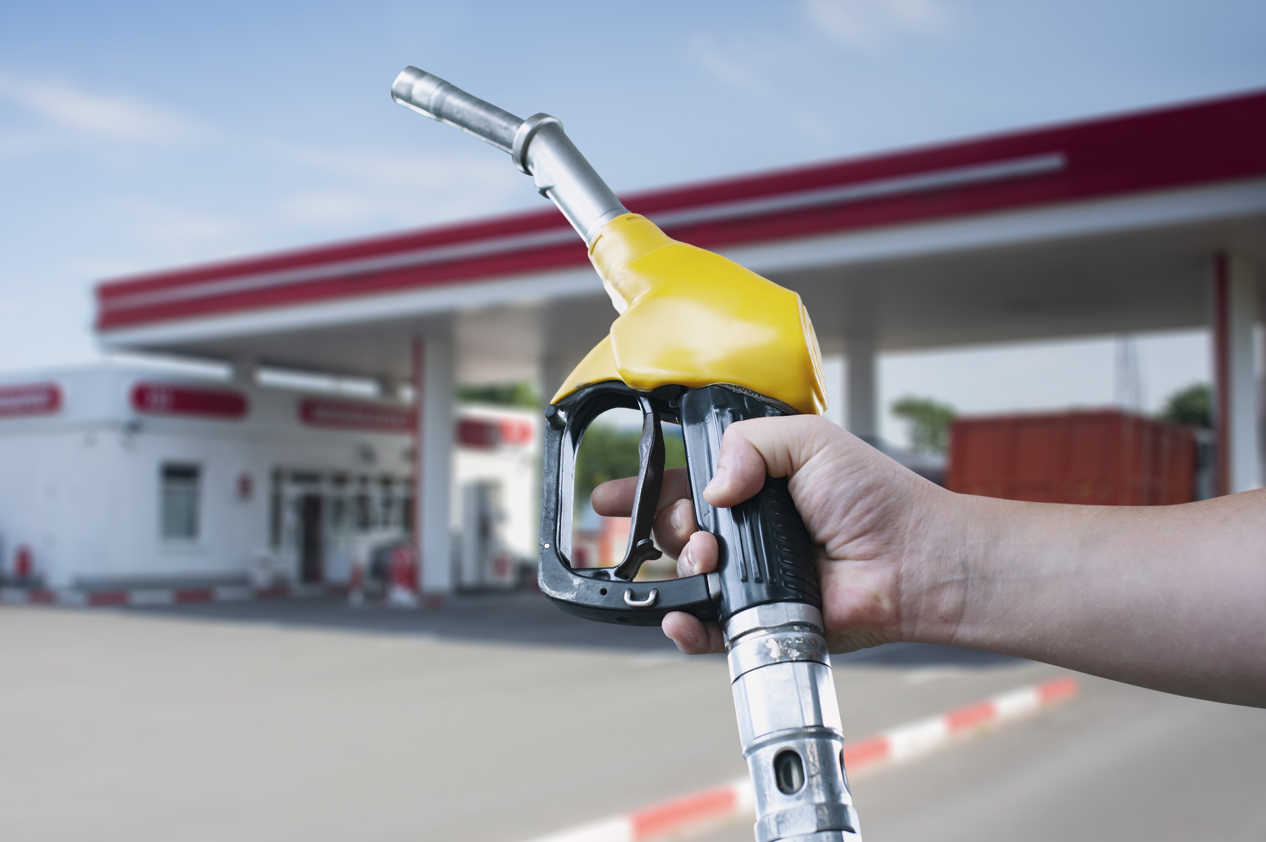 Petrol station with person holding punp